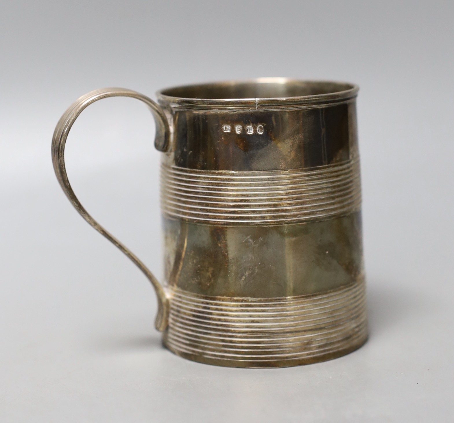 A George III silver mug, with two reeded bands and engraved inscription to the base, no maker's mark, London, 1801, 87mm, 203 grams.